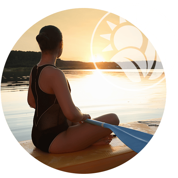 Women on a body board watching the sunset